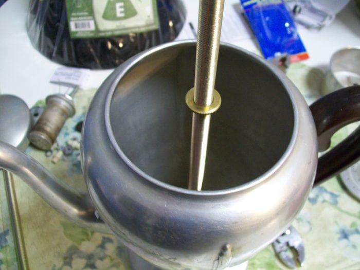 https://www.myrepurposedlife.com/wp-content/uploads/2011/07/thread-nut-onto-lamp-kit-rod-vintage-coffee-pot-lamp-700x525.jpg